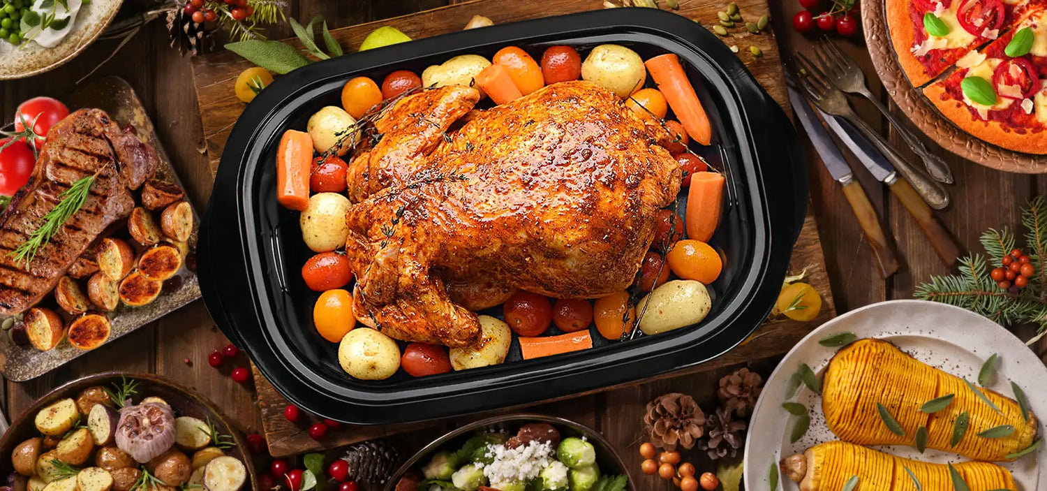 Golden roasted turkey nestled in a black roasting pan, surrounded by colorful vegetables.